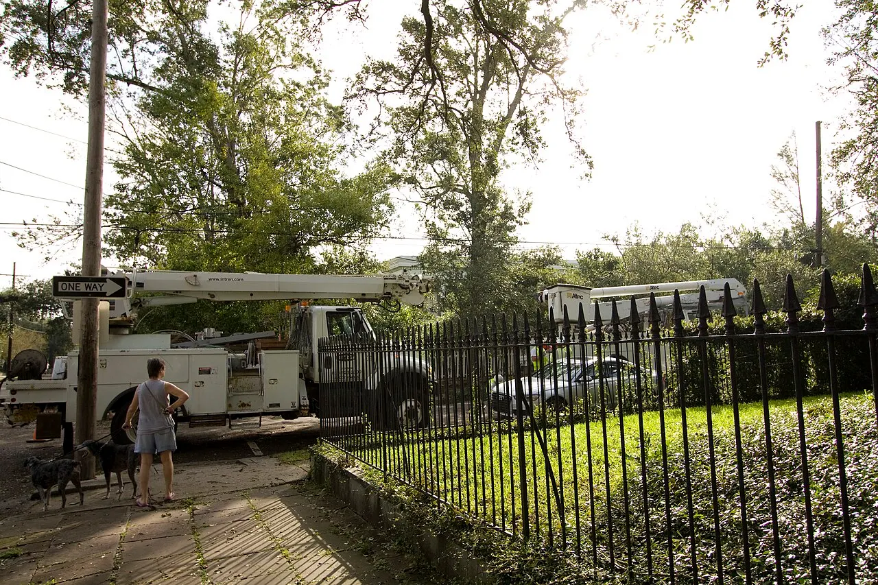Bucket trucks restoring power on a New Orleans street after a storm