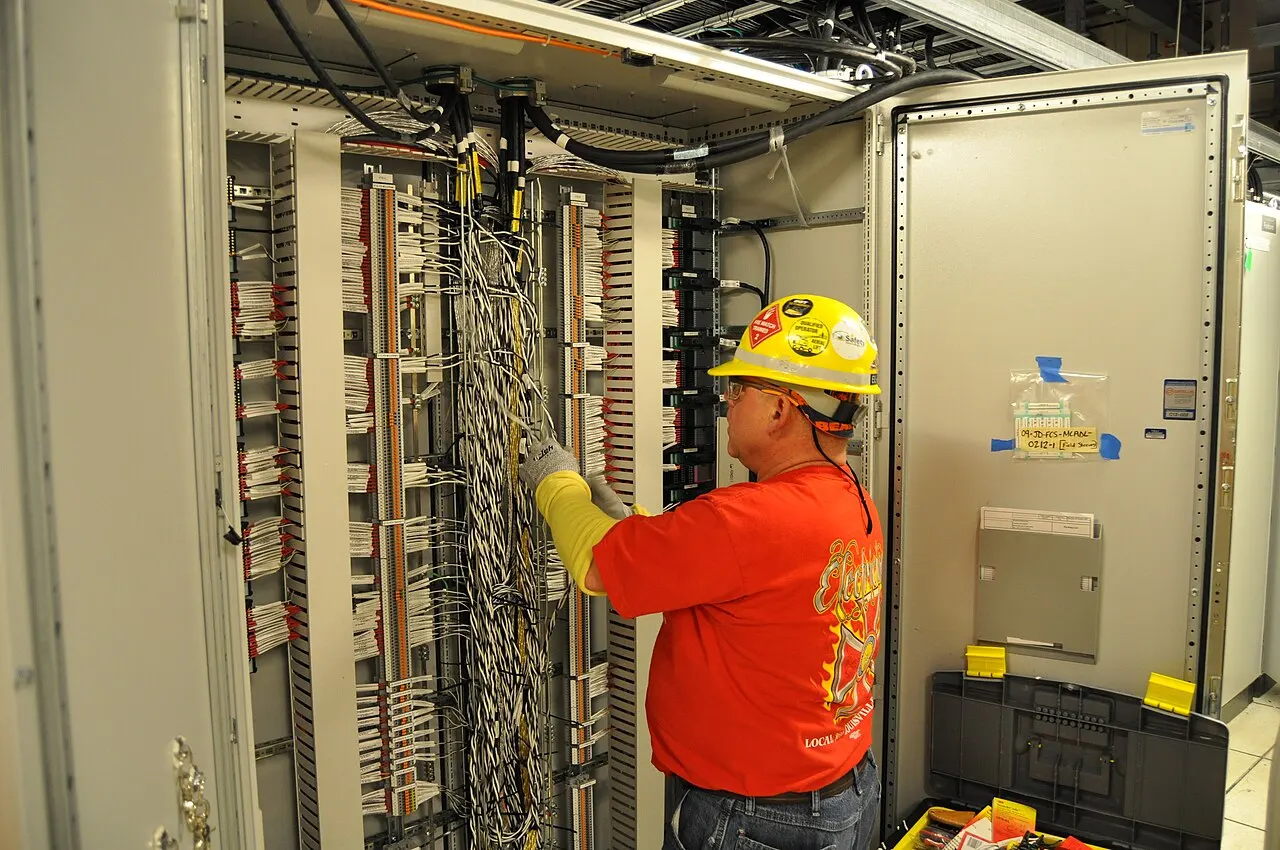 Electrician working inside a commercial control building