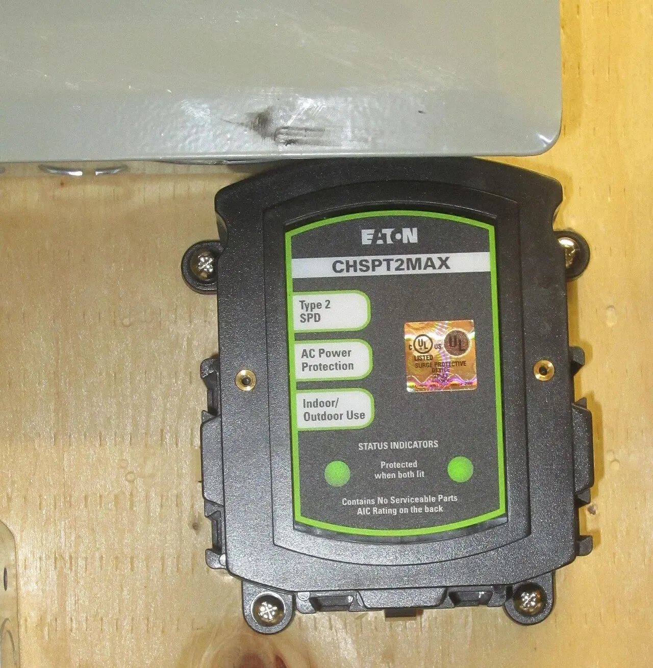 Whole house surge protector mounted at a breaker panel